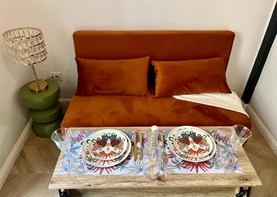 a bed with a table with two plates on it at Studio hyper centre in Ajaccio