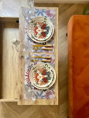 a wooden tray with two plates on a table at Studio hyper centre in Ajaccio