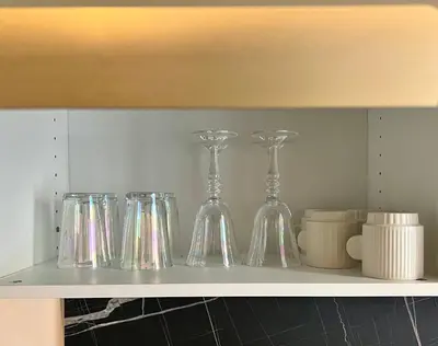 a shelf with glass vases and cups on it at Studio hyper centre in Ajaccio
