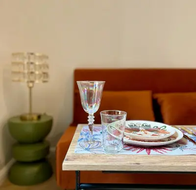 a table with a plate and two glasses on it at Studio hyper centre in Ajaccio