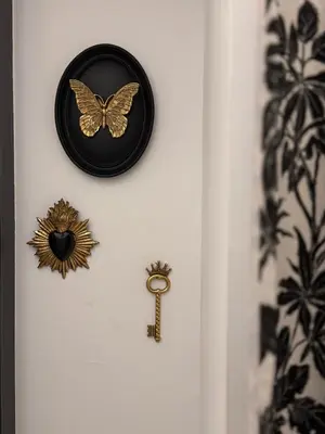 a gold butterfly on a white door with a key at Studio hyper centre in Ajaccio
