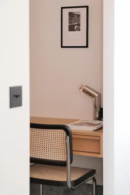 a chair sitting next to a desk with a lamp at Hotel Moderne in Porto-Vecchio