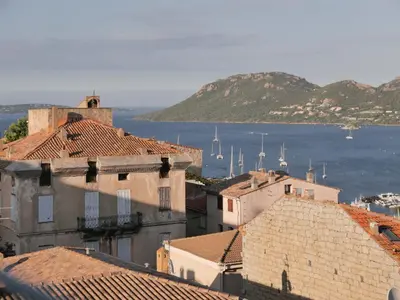 a view of a city with buildings and the water at Hotel Moderne in Porto-Vecchio