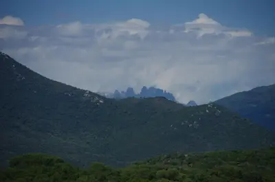 a view of a mountain range with clouds in the sky at Casa Erbaggio in Sartène