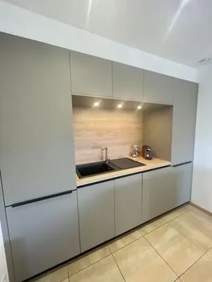 a kitchen with white cabinets and a sink at Villa avec piscine entièrement rénovée à 5min de la plage de pinia in Ghisonaccia