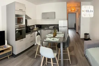 a small kitchen with a table and chairs in a room at Chez Françoise in Porto Ota