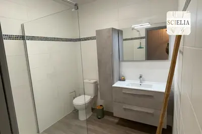 a bathroom with a toilet and a sink and a mirror at Chez Françoise in Porto Ota