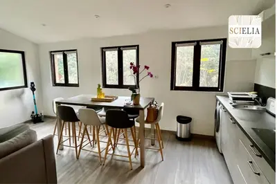 a kitchen with a table and chairs in a room at Chez Françoise in Porto Ota