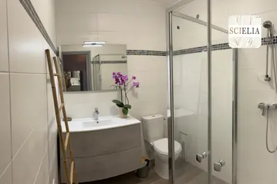 a bathroom with a sink and a toilet and a shower at Chez Françoise in Porto Ota