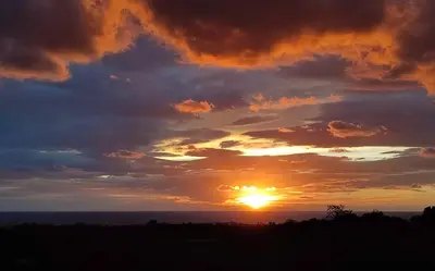 a sunset over the ocean with clouds at côte et mer - appartement haut standing dans villa avec piscine et vue mer in Taglio-Isolaccio