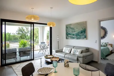 a living room with a couch and a table at Domaine d'Arca - Hugo 06 - 2 pers in Porto-Vecchio