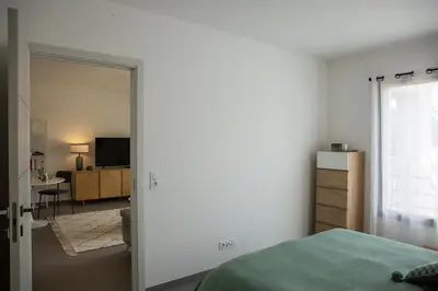 a bedroom with a bed and a desk and a television at Domaine d'Arca - Hugo 06 - 2 pers in Porto-Vecchio