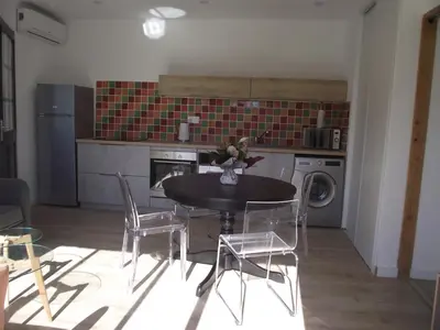 a kitchen with a table and chairs in a room at mer et campagne in Cervione