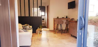 a living room with a couch and a table at Casa in Castirla
