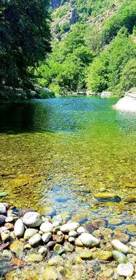 a river with rocks in front of a body of water at Casa in Castirla