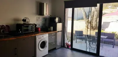 a kitchen with a washing machine and a microwave at Casa in Castirla