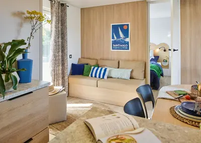 a living room with a couch and a table at Camping California in Pinarellu
