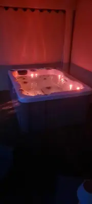 a bath tub with lights in a dark room at Agréable rez de jardin avec Piscine et Jacuzzi in Cervione