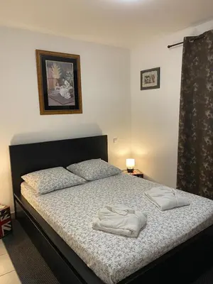 a bedroom with a bed with two towels on it at Agréable rez de jardin avec Piscine et Jacuzzi in Cervione