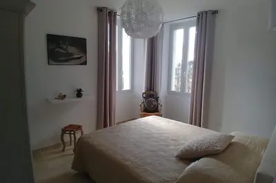 a bedroom with a bed and a window at CHEZ PERLE à LEVIE, logement entier de type T4 in Levie