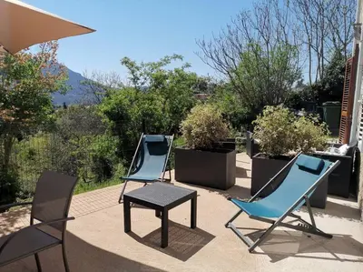two chairs and a table on a patio at CHEZ PERLE à LEVIE, logement entier de type T4 in Levie