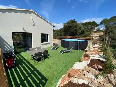 a yard with a pool and chairs and a house at Villa Pacienta in Bonifacio