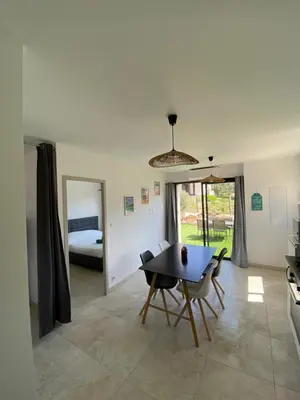 a dining room with a table and a bedroom at Villa Pacienta in Bonifacio