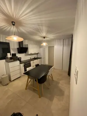 a kitchen with a black table in a room at Villa Pacienta in Bonifacio