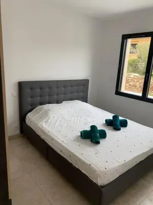 a bed with two blue stuffed animals on it at Villa Pacienta in Bonifacio