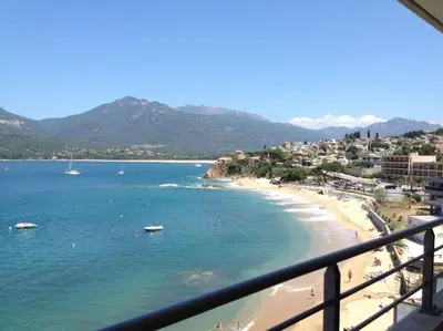 a view of a beach with boats in the water at SUPERBE APPARTEMENT SUR PLAGE VUE PARADISIAQUE PIEDS DANS L'EAU in Propriano