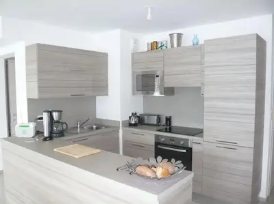 a kitchen with a bowl of fruit on a counter at SUPERBE APPARTEMENT SUR PLAGE VUE PARADISIAQUE PIEDS DANS L'EAU in Propriano