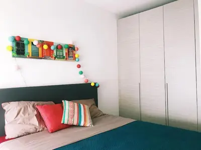 a bedroom with a bed with a christmas decoration above it at SUPERBE APPARTEMENT SUR PLAGE VUE PARADISIAQUE PIEDS DANS L'EAU in Propriano