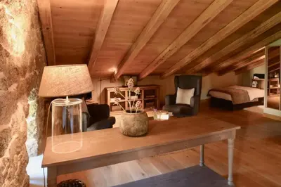 a living room with a table and a bed at Maison Madamicella in Fozzano