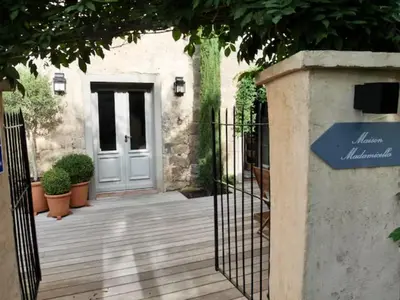 a gate in front of a house with a door at Maison Madamicella in Fozzano