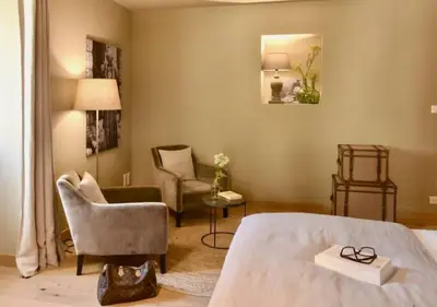 a bedroom with a bed and a chair at Maison Madamicella in Fozzano