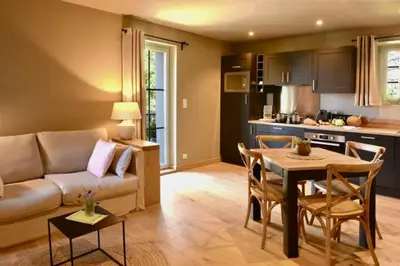 a living room and kitchen with a couch and a table at Maison Madamicella in Fozzano