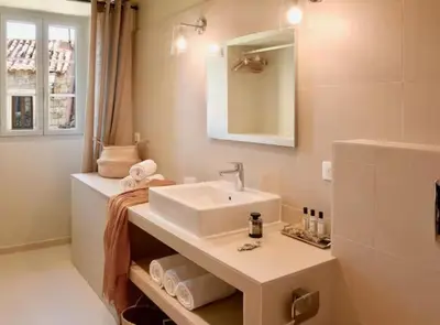a bathroom with a sink and a mirror at Maison Madamicella in Fozzano