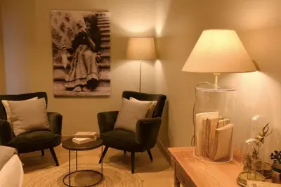 a living room with two chairs and a lamp at Maison Madamicella in Fozzano