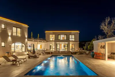 a house with a swimming pool in front of a house at Villa Blue Pearl 10 pers piscine chauffée 10 minutes plage à pieds in Sainte-Lucie de Porto-Vecchio
