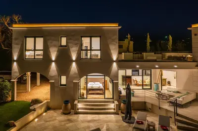 a large house with a patio at night at Villa Blue Pearl 10 pers piscine chauffée 10 minutes plage à pieds in Sainte-Lucie de Porto-Vecchio