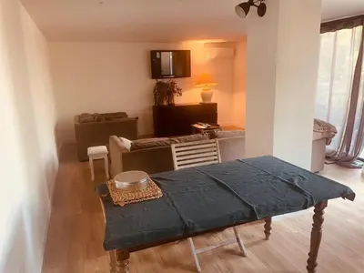 a living room with a couch and a table at T3 dans charmante propriété in Borgo