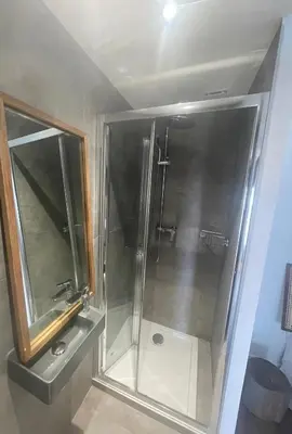 a shower with a glass door in a bathroom at Charmante Propriété Arborée in Borgo