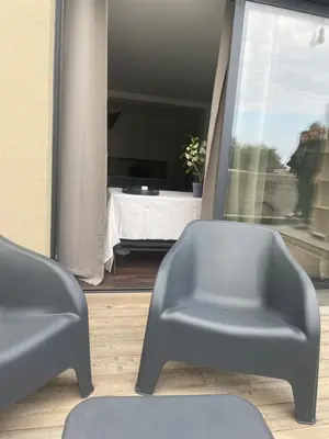 a living room with two chairs and a table at Charmante Propriété Arborée in Borgo