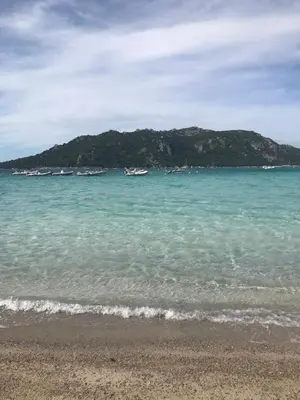 a beach with some boats in the water at Mini villa proche des plus belles plages in Porto-Vecchio