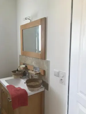 a bathroom with a sink and a mirror at Mini villa proche des plus belles plages in Porto-Vecchio