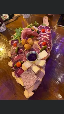 a plate of food with meats and cheese on a table at Mini villa proche des plus belles plages in Porto-Vecchio