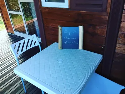 a blue table and two chairs on a porch at Beach house à Marina di Sorbo …Corse in Sorbo-Ocagnano