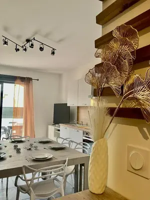 a dining room with a table and a vase with flowers at tytoun evasion in Borgo