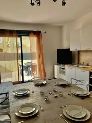 a table with plates and utensils on it in a kitchen at tytoun evasion in Borgo