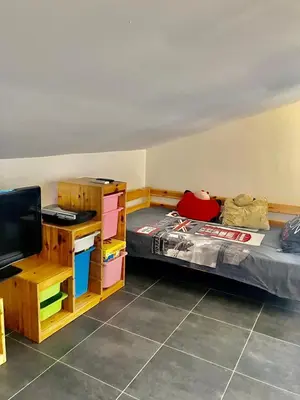 a bedroom with a bed and a desk with a television at tytoun evasion in Borgo